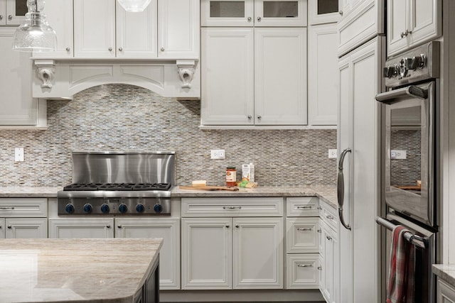 kitchen featuring tasteful backsplash and white cabinetry