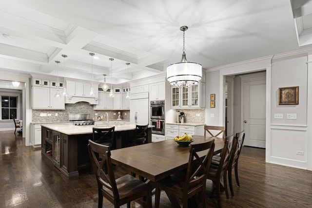 dining room with beamed ceiling, dark hardwood / wood-style floors, ornamental molding, and coffered ceiling