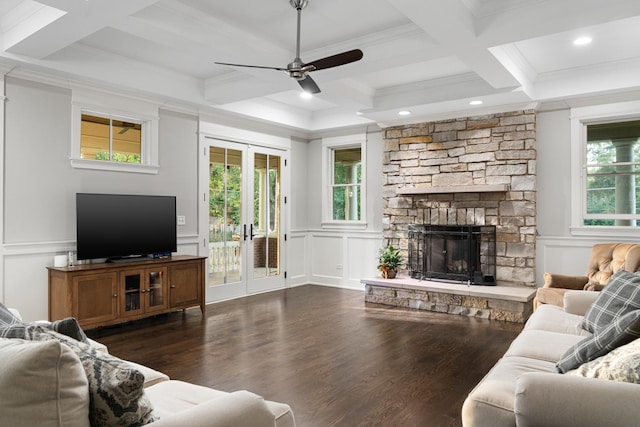 living room featuring coffered ceiling, french doors, ceiling fan, a fireplace, and beam ceiling