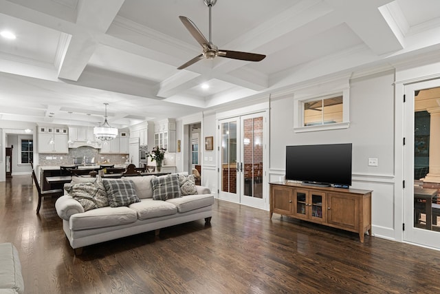 living room with coffered ceiling, crown molding, ceiling fan, beamed ceiling, and dark hardwood / wood-style flooring