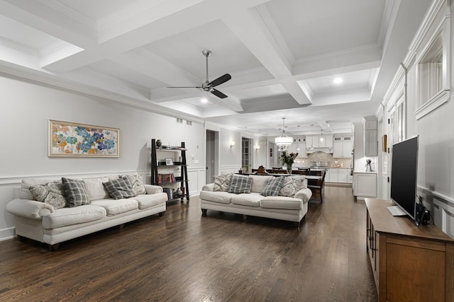 living room featuring dark hardwood / wood-style flooring, ornamental molding, coffered ceiling, ceiling fan, and beam ceiling