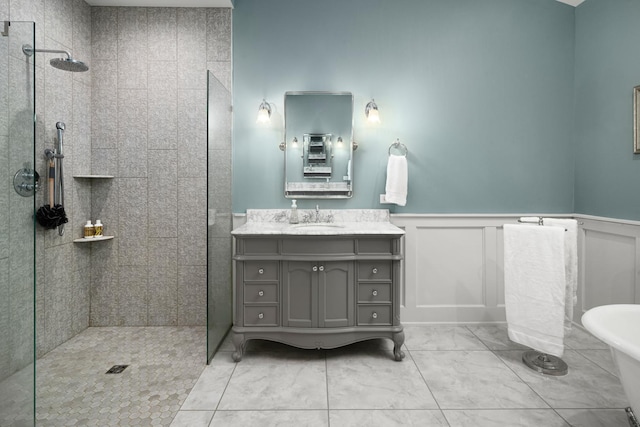 bathroom featuring tile patterned floors, vanity, and tiled shower