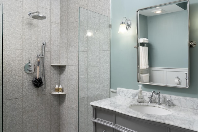 bathroom featuring vanity and tiled shower