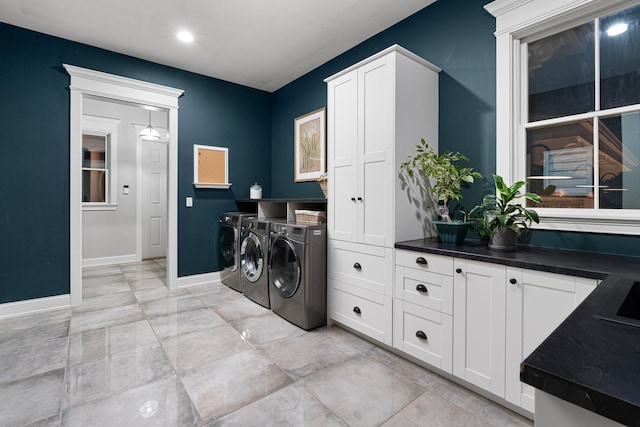 laundry room with cabinets and washing machine and dryer