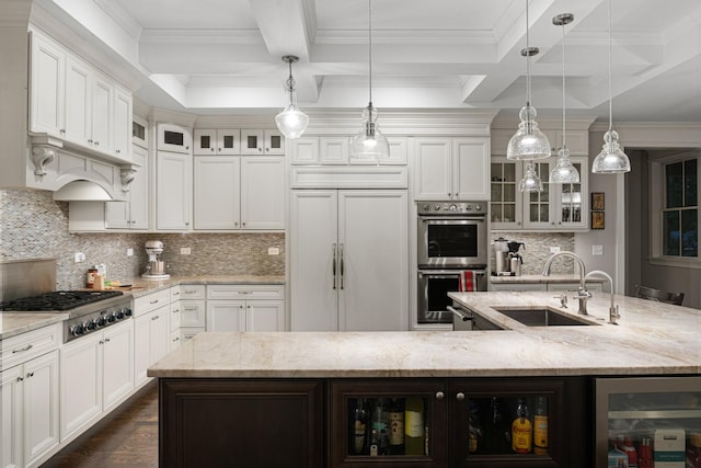 kitchen featuring a large island, pendant lighting, stainless steel appliances, and sink