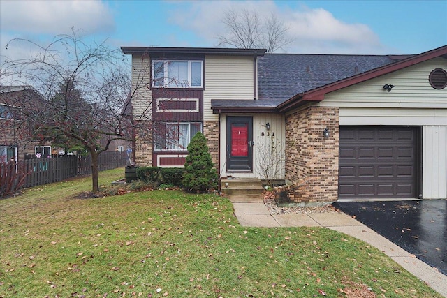 view of front of house featuring a front lawn and a garage