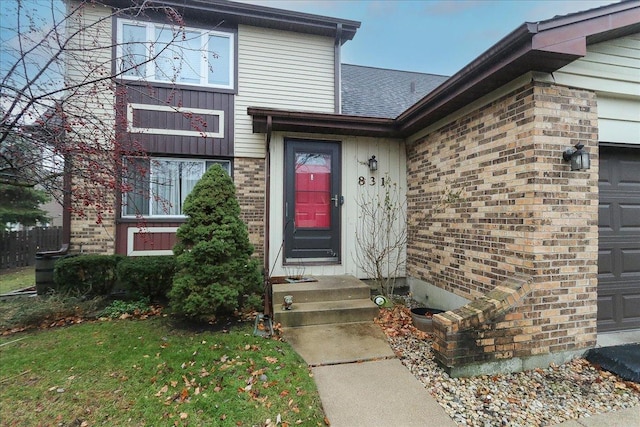 view of exterior entry with a garage