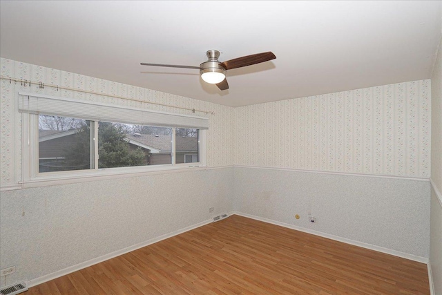 unfurnished room with hardwood / wood-style flooring and ceiling fan