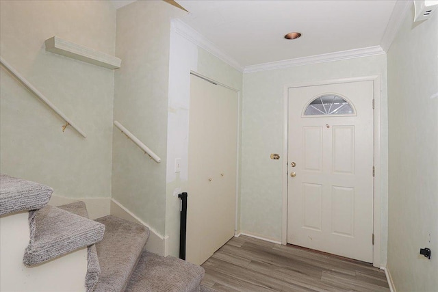 foyer entrance featuring light wood-type flooring and crown molding