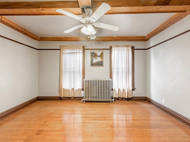 empty room with radiator, ceiling fan, and light hardwood / wood-style floors