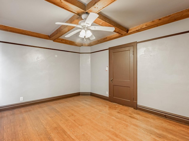 unfurnished room featuring beam ceiling, ceiling fan, coffered ceiling, and light wood-type flooring