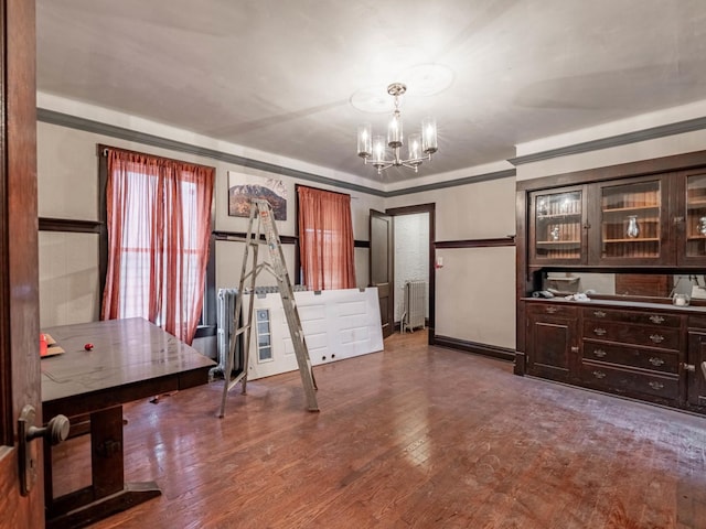 misc room with crown molding, a chandelier, and hardwood / wood-style flooring