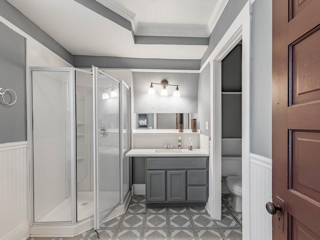 bathroom featuring vanity, toilet, ornamental molding, and walk in shower