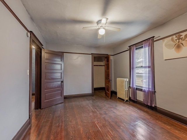 unfurnished bedroom with radiator heating unit, ceiling fan, and dark wood-type flooring