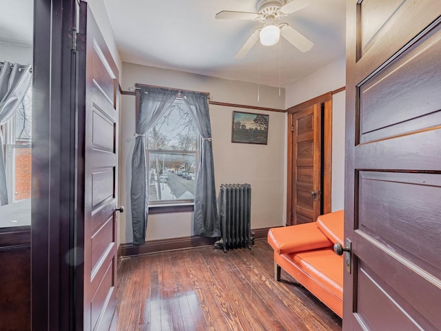 unfurnished room with radiator heating unit, dark hardwood / wood-style floors, and ceiling fan