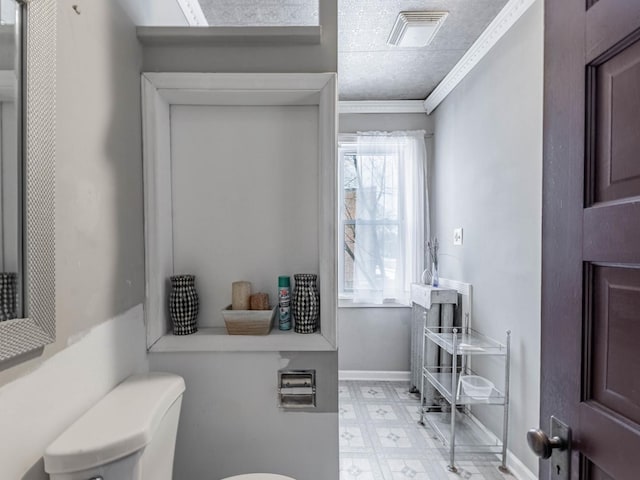 bathroom with toilet and crown molding