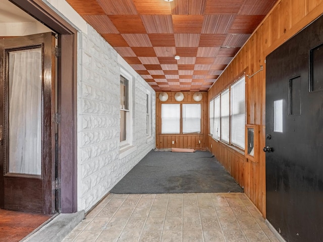 unfurnished sunroom with wooden ceiling