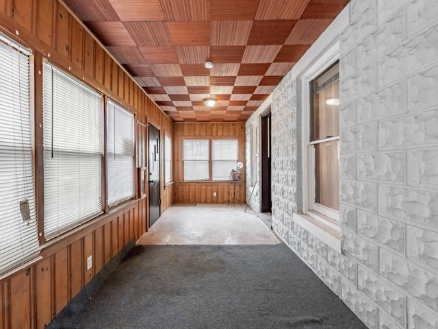 unfurnished sunroom featuring wood ceiling