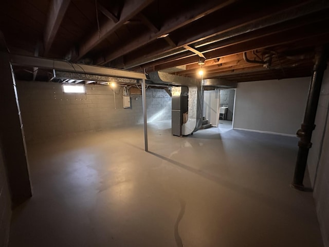 basement featuring electric panel and heating unit