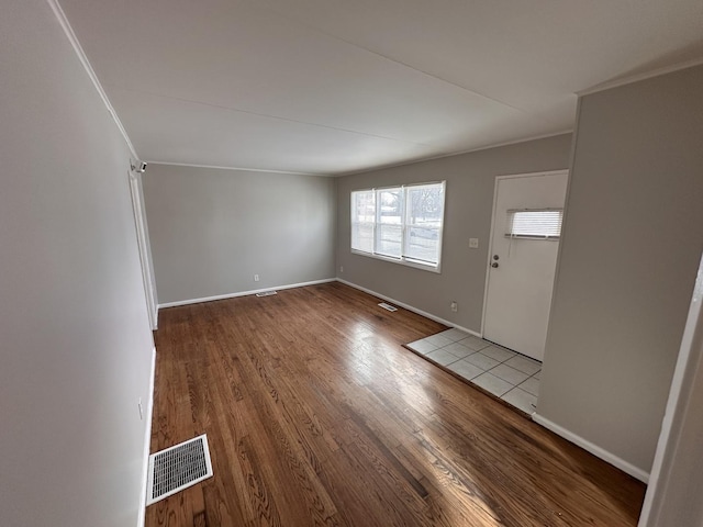 entrance foyer with wood-type flooring and ornamental molding