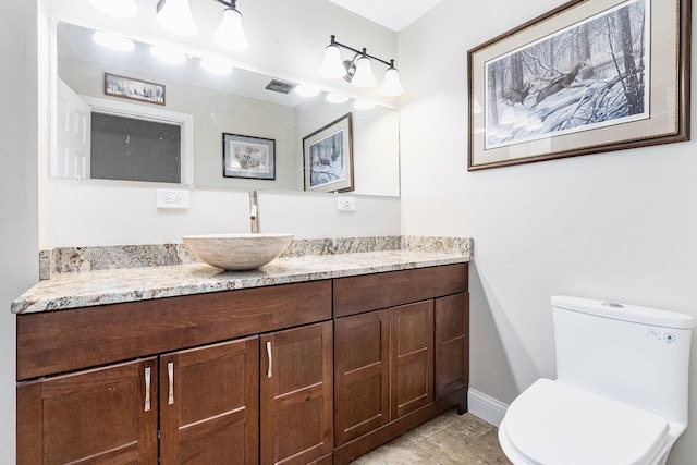 bathroom featuring tile patterned floors, vanity, and toilet