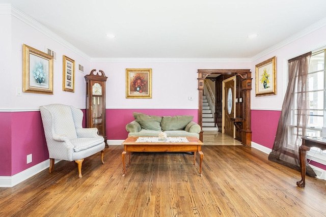 living room with hardwood / wood-style flooring and ornamental molding