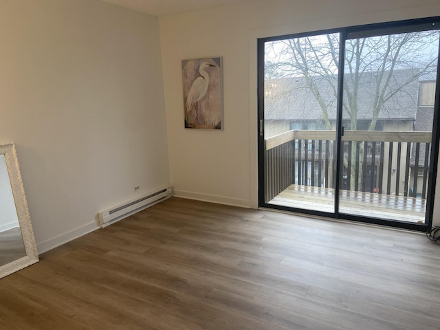 spare room with a baseboard radiator and hardwood / wood-style flooring