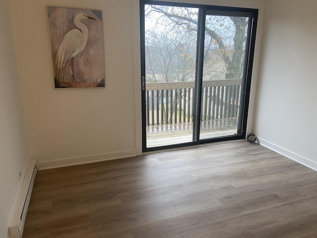 empty room featuring light hardwood / wood-style floors and baseboard heating