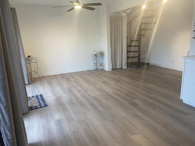 unfurnished living room featuring hardwood / wood-style flooring and ceiling fan