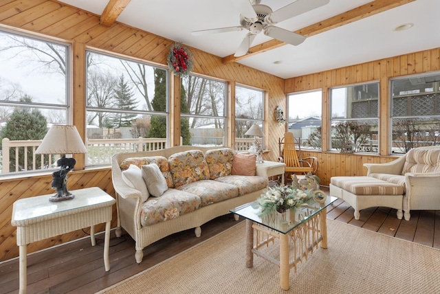 sunroom / solarium featuring beamed ceiling and ceiling fan