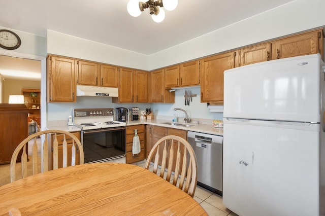 kitchen featuring sink, light tile patterned floors, and white appliances