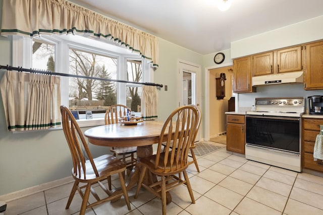 kitchen featuring electric stove and light tile patterned floors