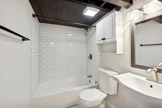 full bathroom with tiled shower / bath, sink, and toilet