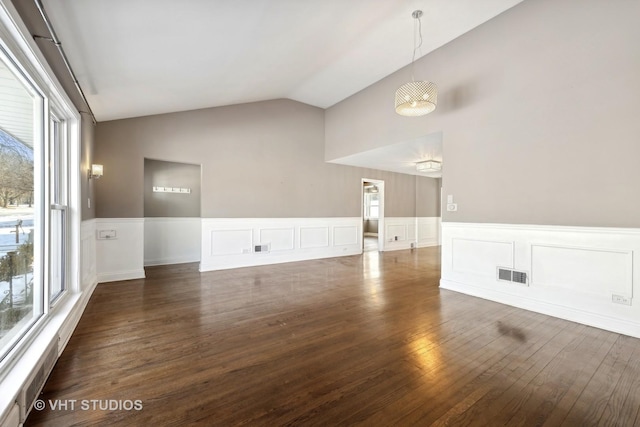 interior space with dark wood-type flooring and lofted ceiling