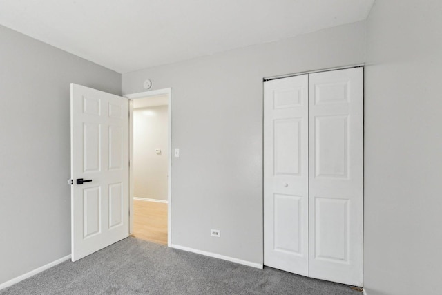 unfurnished bedroom with a closet and carpet floors