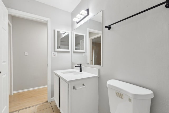 bathroom with tile patterned floors, vanity, and toilet