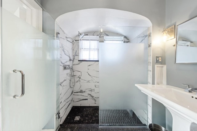 bathroom with sink and a shower with shower door