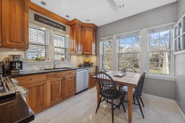 kitchen with sink, decorative backsplash, a wealth of natural light, and dishwasher