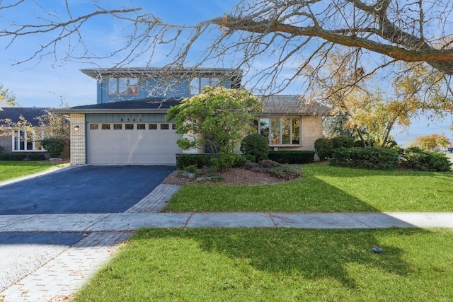 view of front facade with a front lawn and a garage