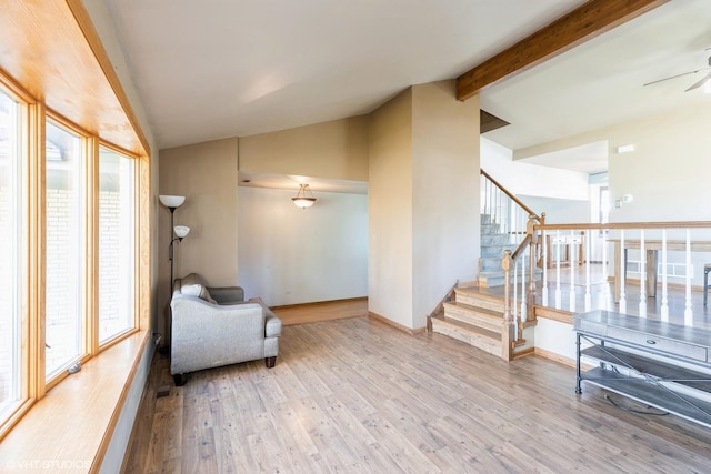 sitting room with hardwood / wood-style floors, vaulted ceiling with beams, and ceiling fan