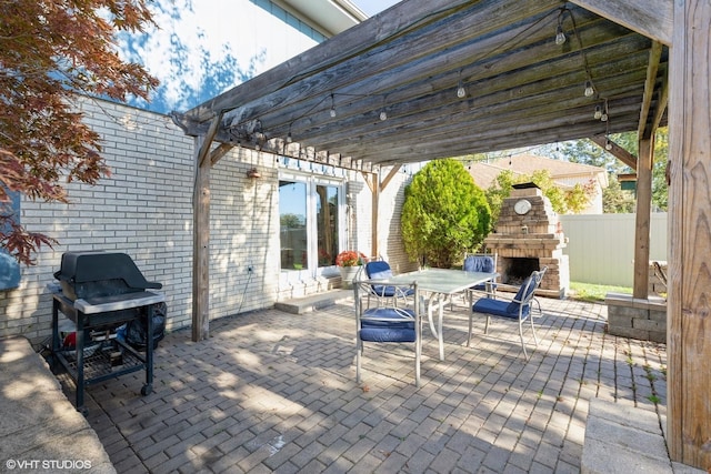 view of patio / terrace featuring an outdoor stone fireplace, area for grilling, and a pergola