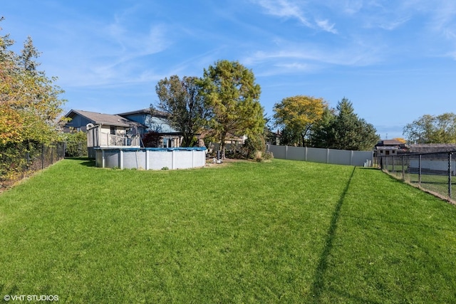 view of yard with a fenced in pool