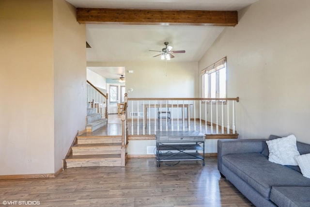 living room with hardwood / wood-style floors, ceiling fan, and lofted ceiling with beams