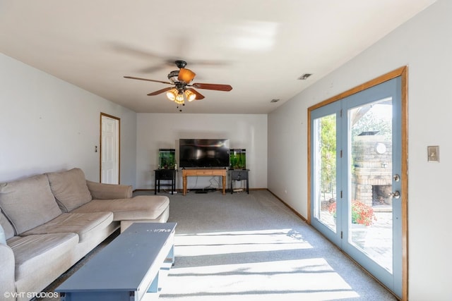 carpeted living room featuring ceiling fan