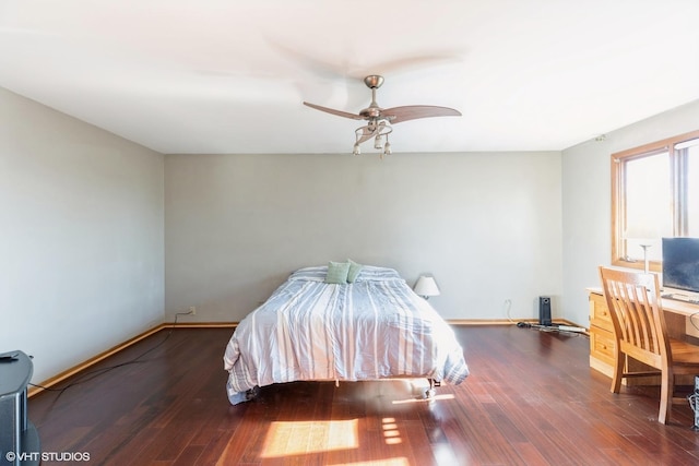 bedroom with ceiling fan and dark hardwood / wood-style flooring