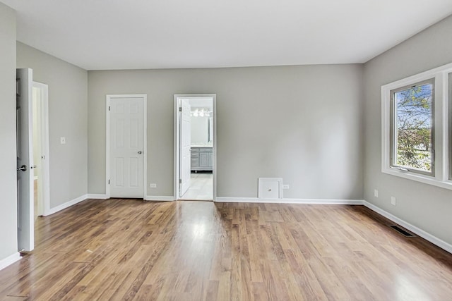 spare room featuring light hardwood / wood-style flooring