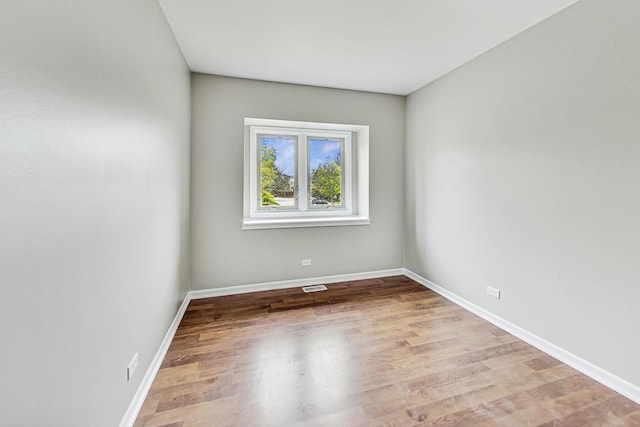 unfurnished room with light wood-type flooring