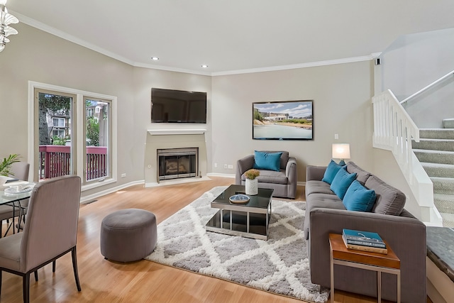 living room with hardwood / wood-style flooring and crown molding