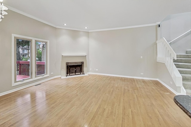 unfurnished living room featuring light hardwood / wood-style floors and crown molding