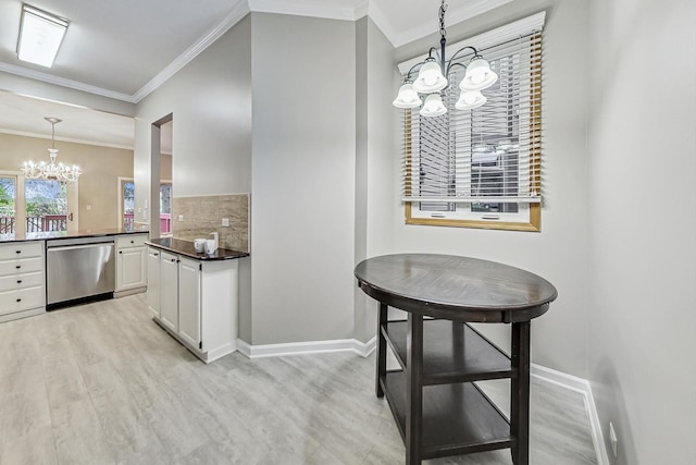 kitchen with white cabinets, dishwasher, hanging light fixtures, and a chandelier